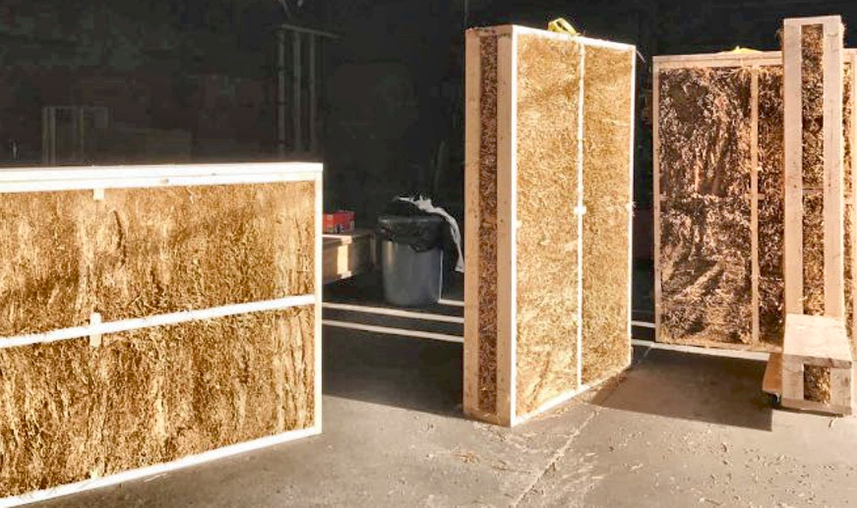 Compressed-straw structural panels in twin timber frames